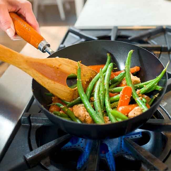 Ken Hom Classic Non-Stick Carbon Steel Mini Wok, 7.75” in use